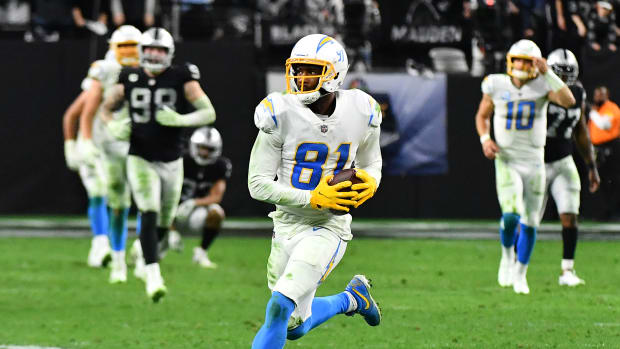 Jan 9, 2022; Paradise, Nevada, USA; Los Angeles Chargers wide receiver Mike Williams (81) gains yardage against the Las Vegas Raiders during an overtime period at Allegiant Stadium. Mandatory Credit: Stephen R. Sylvanie-USA TODAY Sports